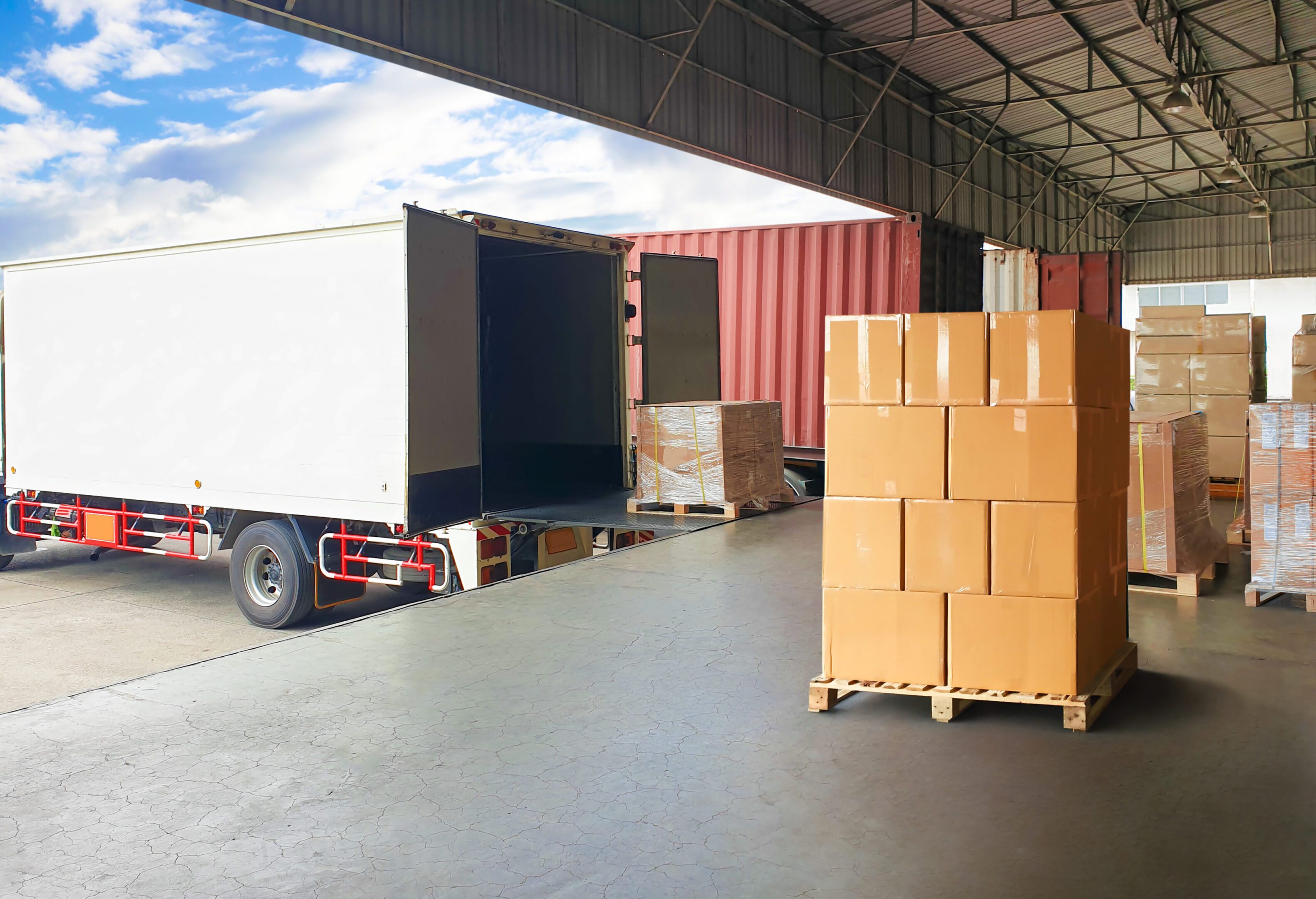 Loading dock with truck and stacked boxes.