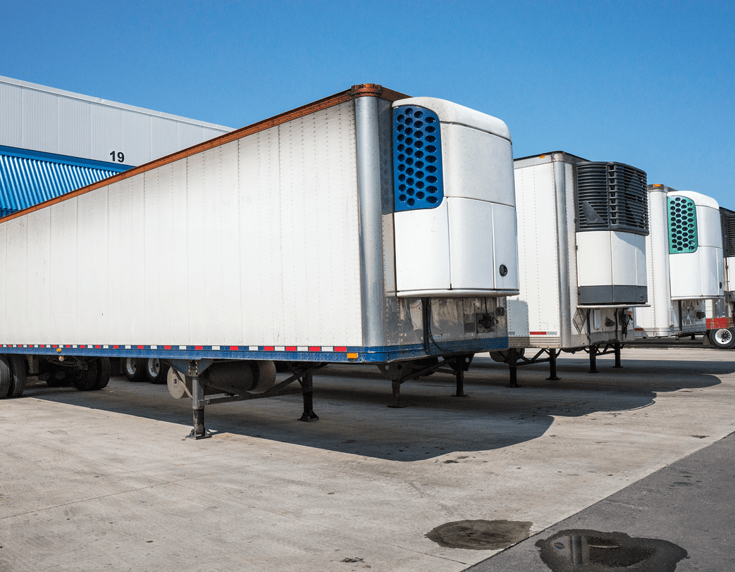 Refrigerated trailers parked at a loading dock.